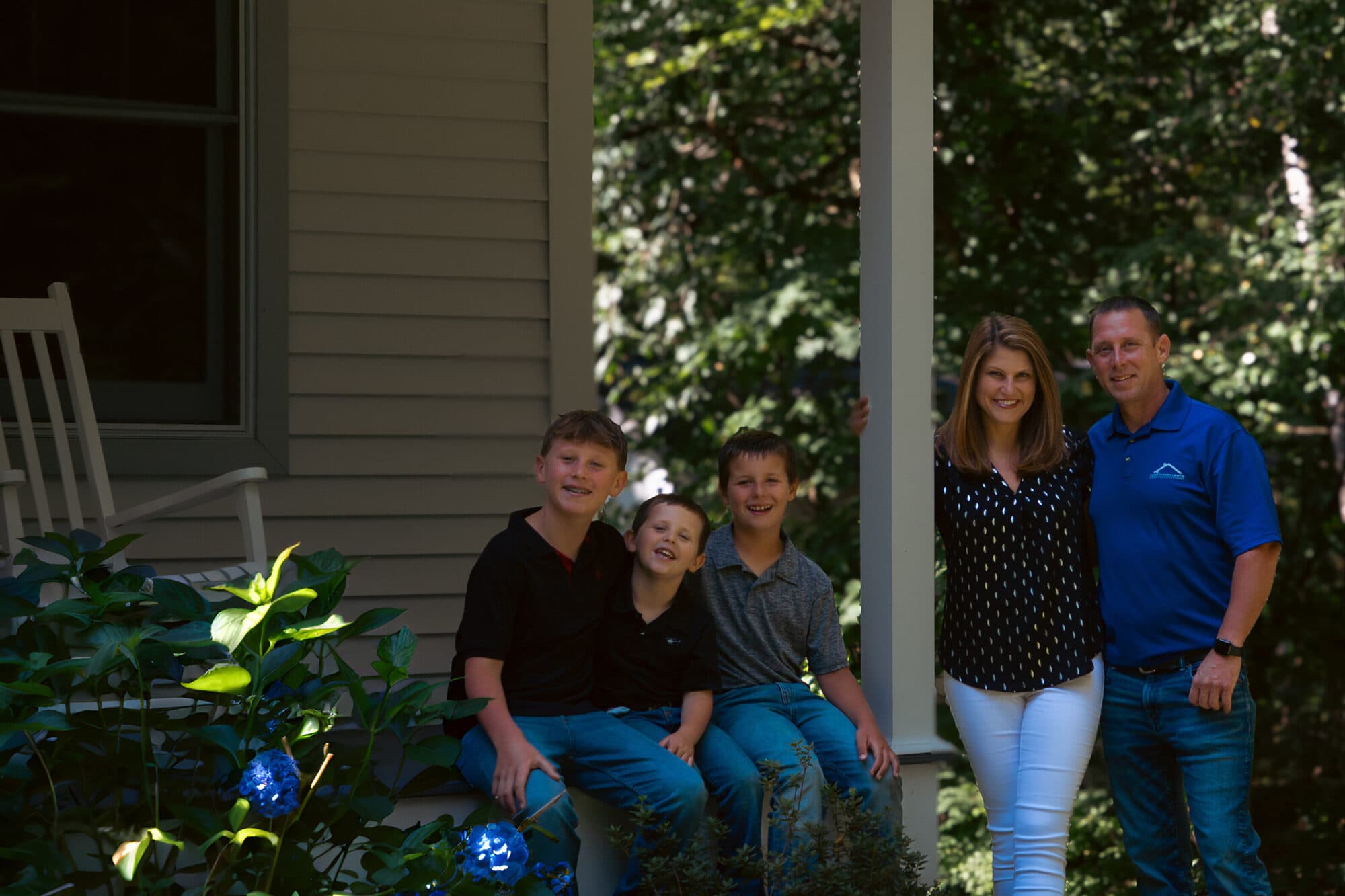 Tim North with his wife and three sons on the front porch of their Central Connecticut home