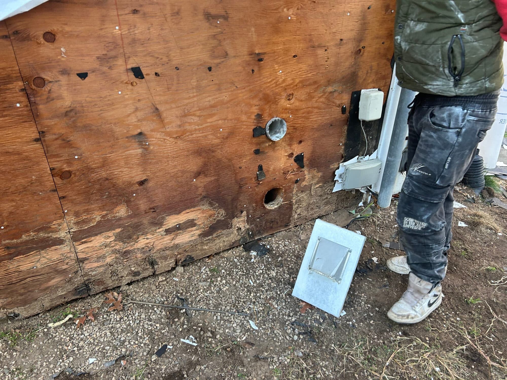 Rotted wall sheathing exposed during a Northern Limits storm-damage repair
